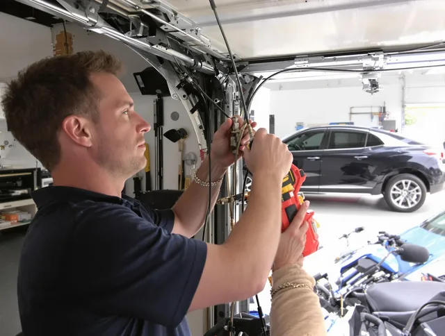 Fairview Park Garage Door Repair safety certified technician performing cable replacement in Fairview Park